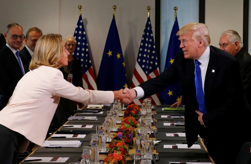 U.S. President Donald Trump (R) shakes hands with European Union foreign policy chief Federica Mogherini before their meeting at the European Union headquarters in Brussels, Belgium, May 25, 2017. (photo credit: REUTERS)