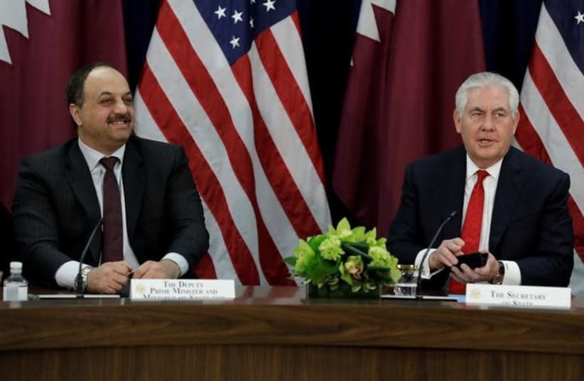 US Secretary of State Rex Tillerson (R) speaks next to Qatari Defense Minister Khalid bin Muhammad al-Attiyah at the opening session of the inaugural US-Qatar Strategic Dialogue at the State Department in Washington, US, January 30, 2018 (photo credit: REUTERS/YURI GRIPAS)