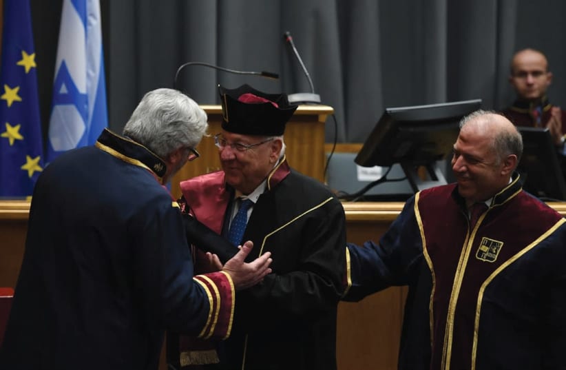 PRESIDENT REUVEN RIVLIN (center) is congratulated following the conferral of his honorary doctorate by the University of Piraeus. (photo credit: HAIM ZACH/GPO)