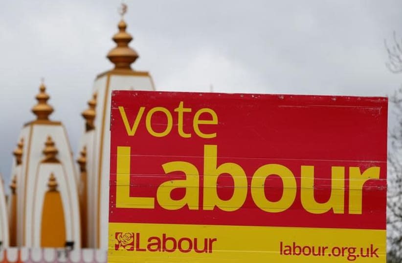 A vote Labour sign is seen near the Gita Bhavan Hindu Temple in Whalley Range, Manchester, Britain April 20, 2017 (photo credit: REUTERS/ANDREW YATES)