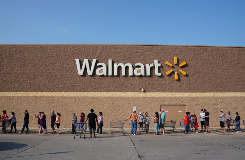 People line up outside a Walmart store (photo credit: CARLO ALLEGRI/REUTERS)
