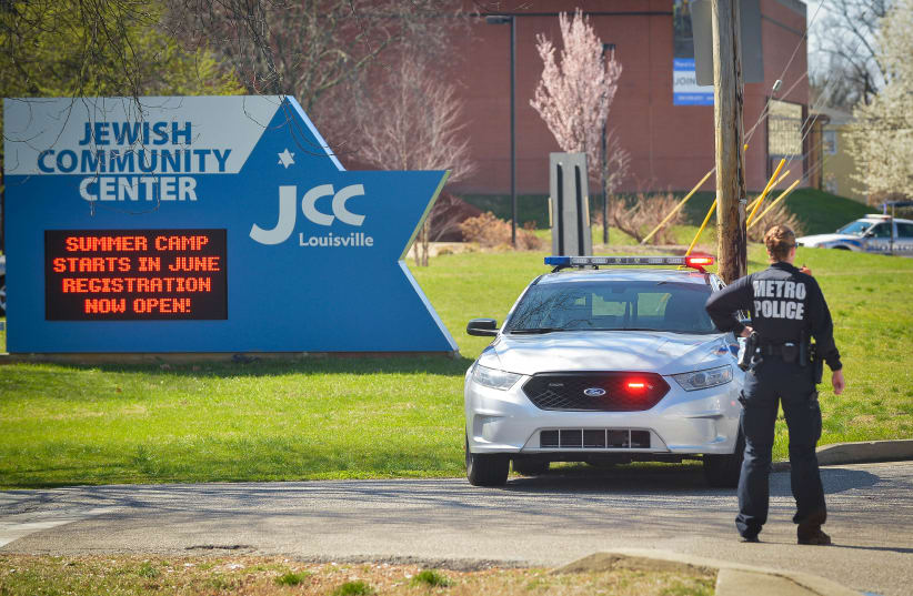 A police officer blocks an entrance as officials respond to a bomb threat at the Jewish Community Center in Louisville, Kentucky. (photo credit: REUTERS)