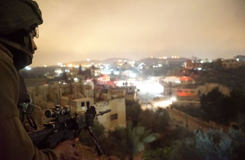 An IDF sniper during a raid the West Bank village of Al-Yamun (photo credit: IDF SPOKESPERSON'S UNIT)