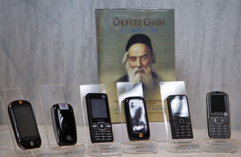 Kosher cellular phones, imported and distributed by Israeli Accel Telecom, are displayed at the company's offices in Tel Aviv (photo credit: NIR ELIAS / REUTERS)