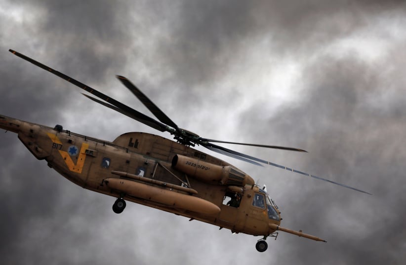 An Israeli Air Force Sikorsky CH-53 helicopter flies during an aerial demonstration at a graduation ceremony for Israeli Air Force pilots at the Hatzerim air base in southern Israel, December 27, 2017. (photo credit: REUTERS/AMIR COHEN)