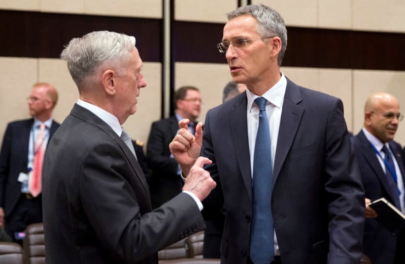 US Secretary for Defense Jim Mattis talks with NATO Secretary General Jens Stoltenberg prior to a meeting on the sidelines of a NATO defence ministers meeting at NATO headquarters in Brussels, Belgium (photo credit: REUTERS/VIRGINIA MAYO/POOL)
