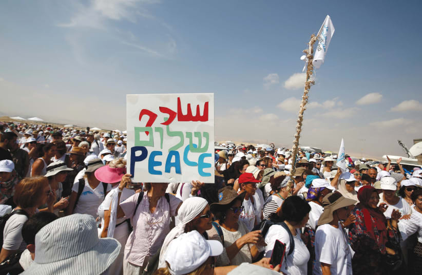 Activists march in support of peace.  (photo credit: REUTERS)