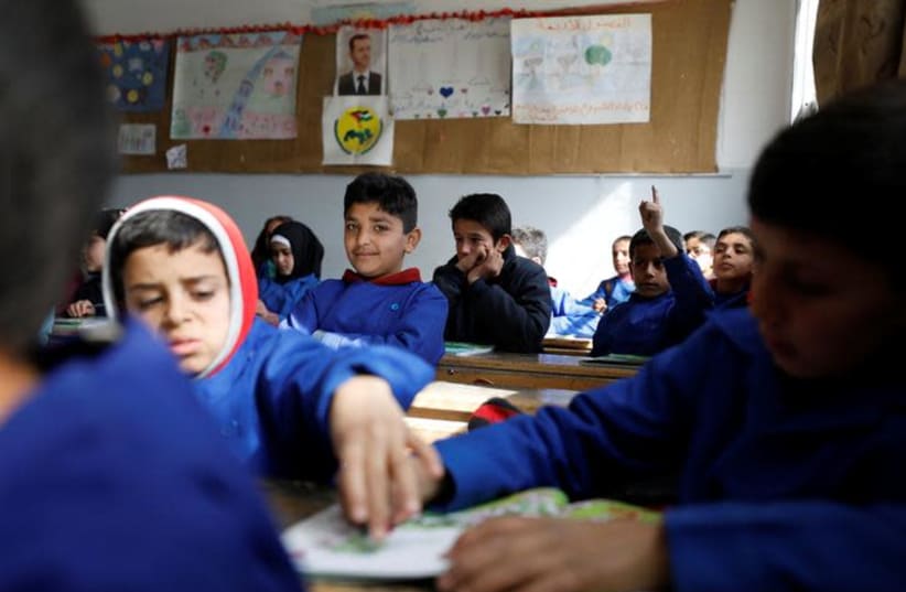 Students sit in a classroom at a school in Sahnaya, near Damascus Syria February 4, 2018. Picture taken February 4, 2018. REUTERS/Omar Sanadiki (photo credit: OMAR SANADIKI/REUTERS)