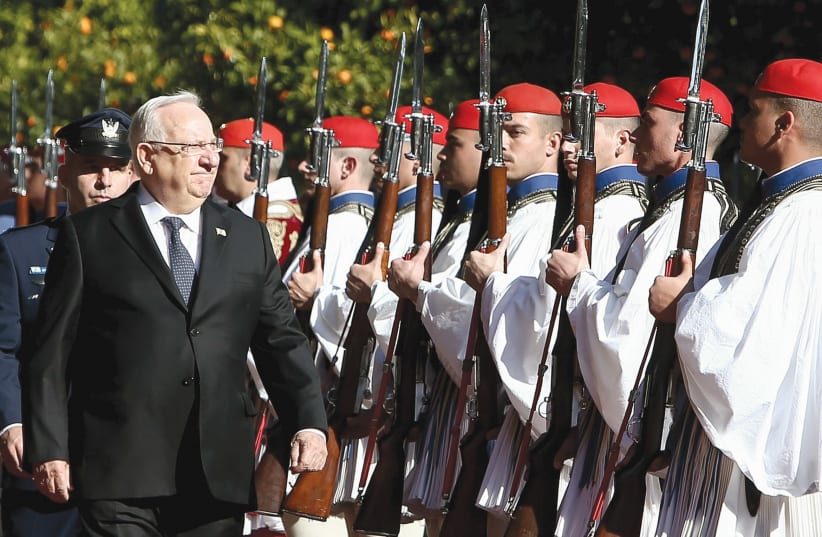 PRESIDENT REUVEN RIVLIN inspects a guard of honour during a welcome ceremony in Athens in January, 2018.. (photo credit: REUTERS)