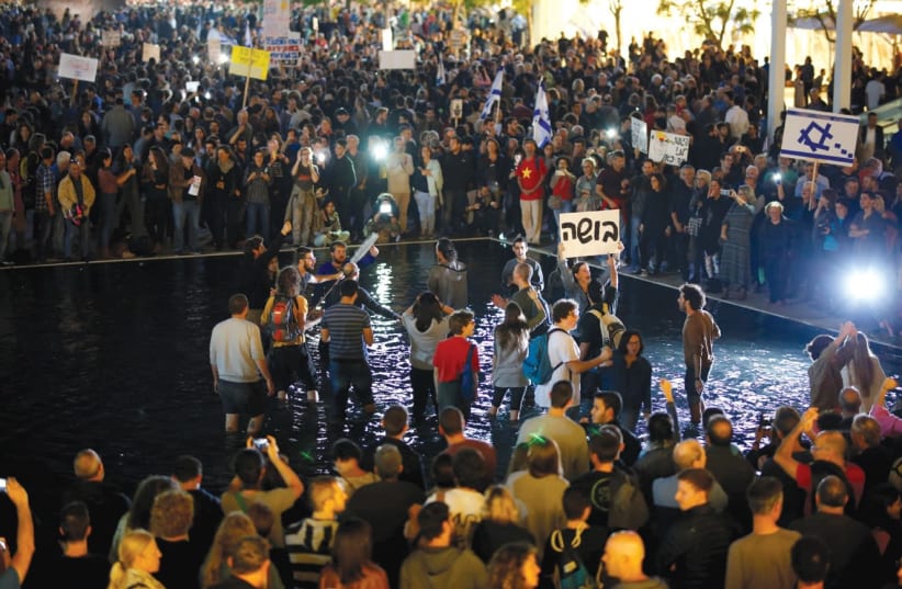 ANTI-CORRUPTION PROTESTERS in Tel Aviv in December. (photo credit: REUTERS)