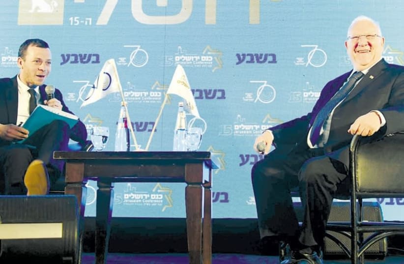 President Reuven Rivlin (right) is interviewed by TV journalist Amit Segal yesterday at the 15th annual Jerusalem Conference of the Besheva Group (photo credit: MARK NEIMAN)