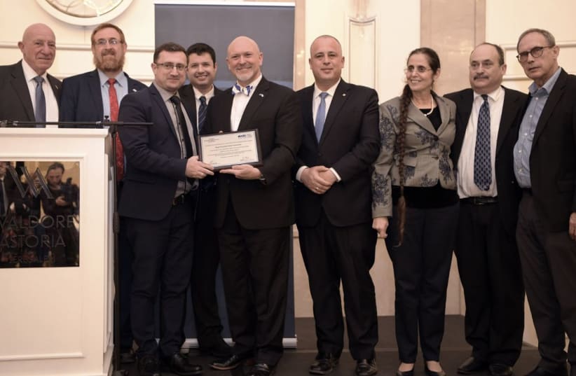South Carolina State Rep. Alan Clemmons receives a lifetime achievement  award from the Knesset Christian Allies Caucus and World Jewish Congress. Pictured from left: Colonel Moshe Leshem, MK Yehudah Glick, MK Robert Ilatov, caucus director Josh Reinstein, Clemmons, MKs Hilik Bar and Anat Berko, WJC (photo credit: GIL HOFFMAN)