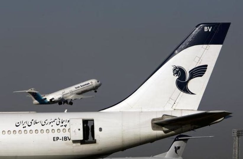 An Iranian Aseman Airlines' Fokker 100 takes off as an Iran Air aircraft is seen in the foreground at Tehran's international airport August 6, 2007.  (photo credit: REUTERS/MORTEZA NIKOUBAZL)