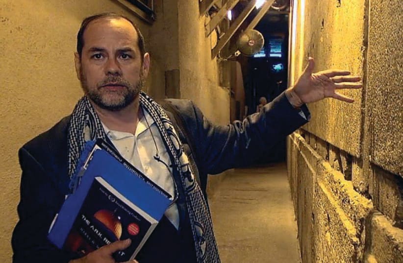 Harry Moskoff, holding his book, tours the Western Wall tunnels (photo credit: HARRY MOSKOFF)