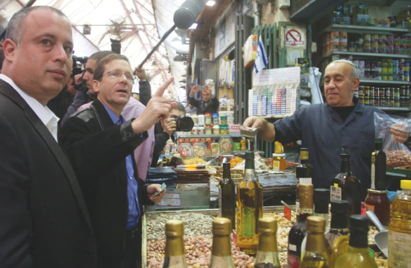 An unidentified hipster shops for artisanal walnut oil, just before the pompous ‘balagan’ that shook the shuk last Friday (photo credit: MARC ISRAEL SELLEM)