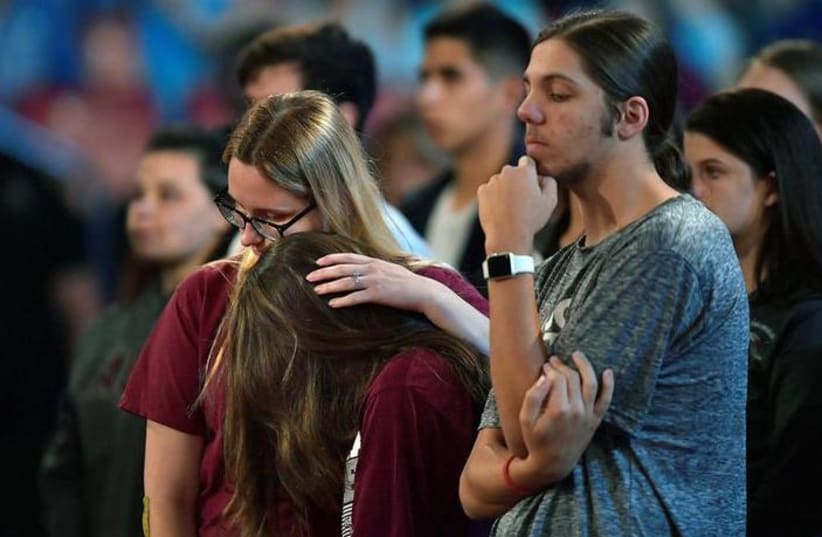 Marjory Stoneman Douglas High School students listen to sheriff Scott Israel speak before a CNN town hall meeting at the BB&T Center, in Sunrise, Florida, US February 21, 2018. (photo credit: REUTERS/MICHAEL LAUGHLIN/POOL)