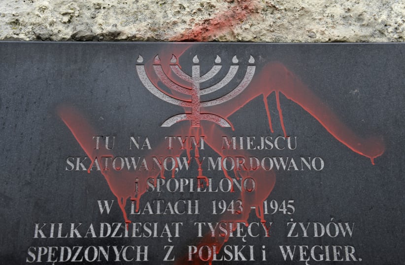 Antisemitic graffiti is seen on a monument dedicated to the victims of the Krakow ghetto, 2010. (photo credit: REUTERS / PAWEL ULATOWSKI)