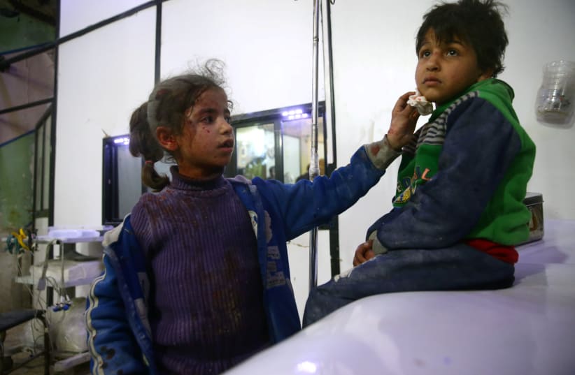 Wounded children are seen in a hospital in the besieged town of Douma, Eastern Ghouta, Damascus, Syria February 23, 2018.  (photo credit: REUTERS/BASSAM KHABIEH)