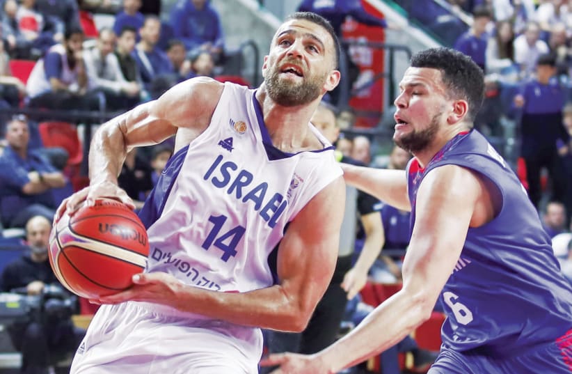 Israel guard Raviv Limonad drives to the basket to score two of his 15 points during Friday’s 82-75 victory over Great Britain in Tel Aviv (photo credit: DANNY MARON)