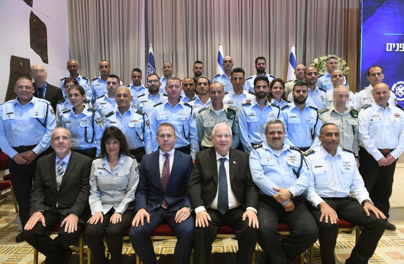 President Reuven Rivlin and Police Commissioner Insp.-Gen. Roni Alsheich meet with honorees on February 27th, 2018. (photo credit: Mark Neiman/GPO)