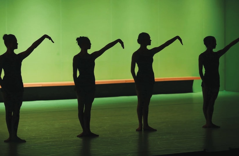 THE DANCERS are clad in simple black outfits and surrounded by fluorescent green walls and lighting – lending the stage an eerie, otherworldly ambience. (photo credit: ASCAF AVRAHAM)