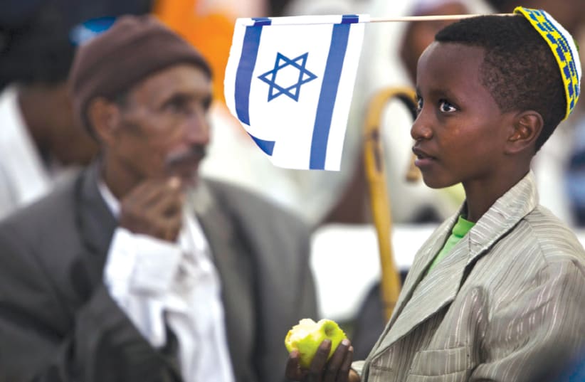 A YOUNG immigrant from Ethiopia waits upon his arrival at Ben-Gurion in 2012 (photo credit: REUTERS/NIR ELIAS)
