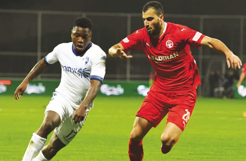 Ironi Kiryat Shmona's Dutch striker Nigel Hasselbaink (left) terrorized Loai Taha (right) and Hapoel Beersheba once again last night, netting the only goal of the match to secure his team’s upset triumph in the quarterfinals of the State Cup (photo credit: ANCHO GOSH)