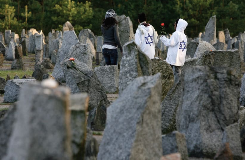 YOUTHS STAND among stones at Treblinka Nazi Death Camp memorial. (photo credit: REUTERS)