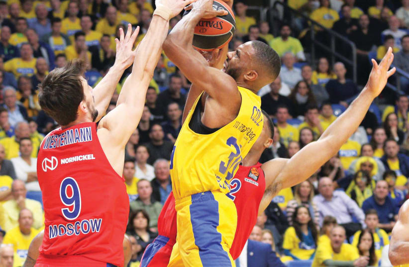Maccabi Tel Aviv guard Norris Cole (with ball) couldn’t find a way through CSKA Moscow’s defense last night, with the yellow-and-blue being outplayed by its old rival in a 93-73 defeat in Euroleague action at Yad Eliyahu Arena. (photo credit: ADI AVISHAI)