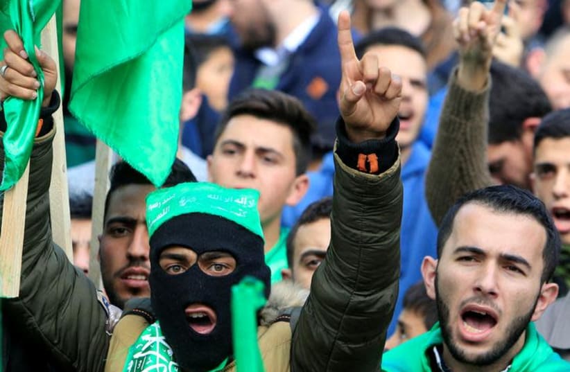 Palestinian Hamas supporters shout slogans during a rally marking the 30th anniversary of Hamas' founding, in the West Bank city of Nablus December 15, 2017. REUTERS/Abed Omar Qusini (photo credit: ABED OMAR QUSINI/REUTERS)