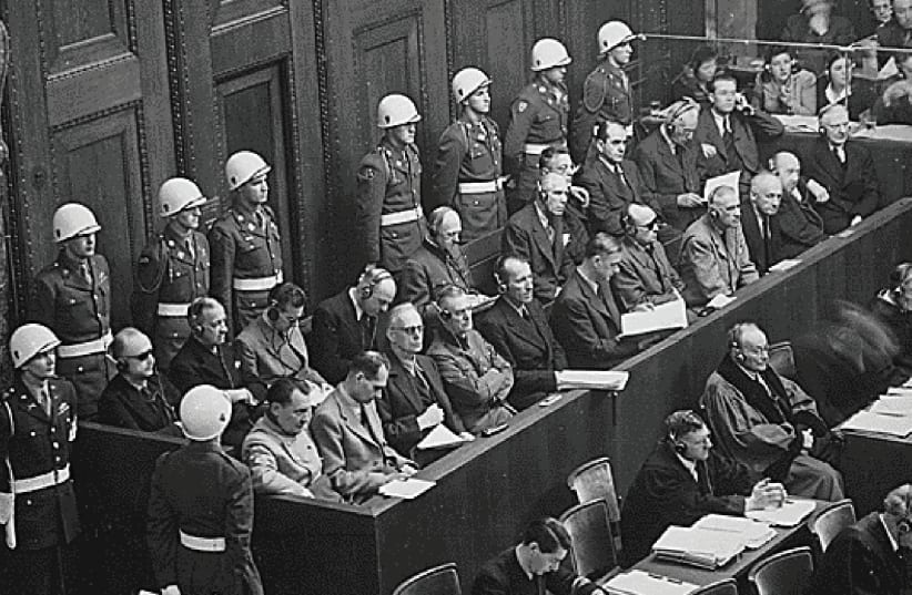 THE DEFENDANTS, including Joachim von Ribbentrop in the front row, sit in the dock at Nuremberg in 1946. (photo credit: REUTERS)