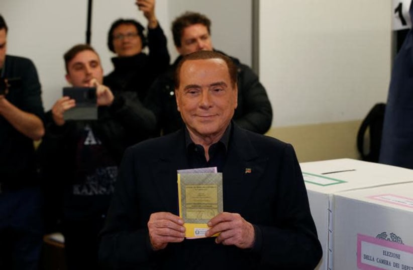 Forza Italia party leader Silvio Berlusconi casts his vote at a polling station in Milan, Italy March 4, 2018. (photo credit: REUTERS/STEFANO RELLANDINI)