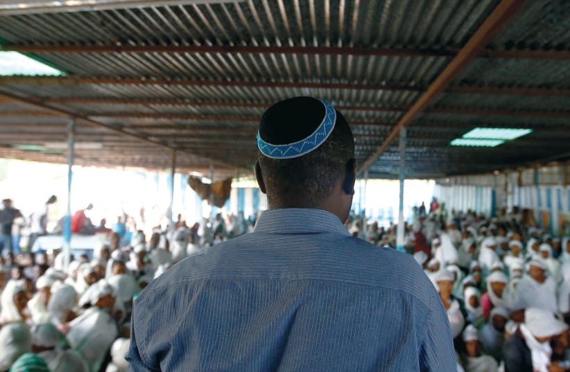 AN ELDER leads members of the Falash Mura Jewish Ethiopian community in a morning prayer service. (Reuters) (photo credit: REUTERS)
