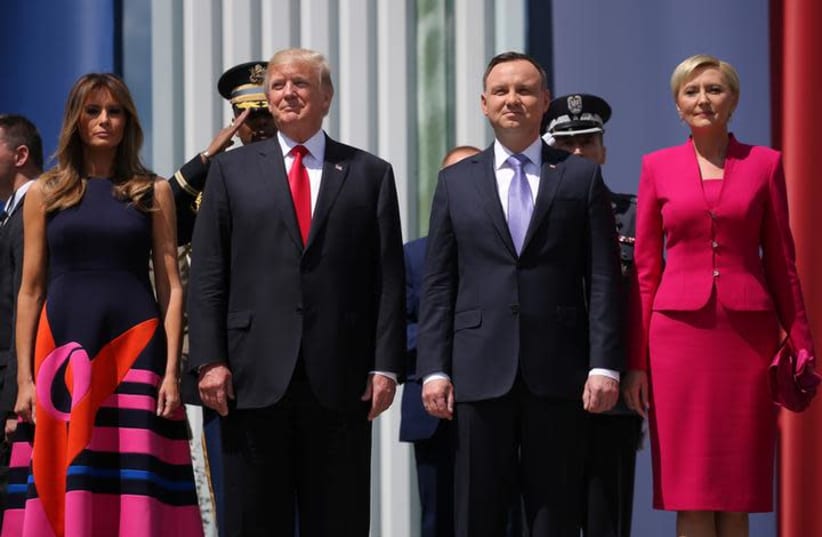 U.S. President Donald Trump stands next to First Lady Melania Trump, Polish President Andrzej Duda and Polish First Lady Agata Kornhauser-Duda before his public speech at Krasinski Square, in Warsaw, Poland July 6, 2017. (photo credit: REUTERS/CARLOS BARRIA)