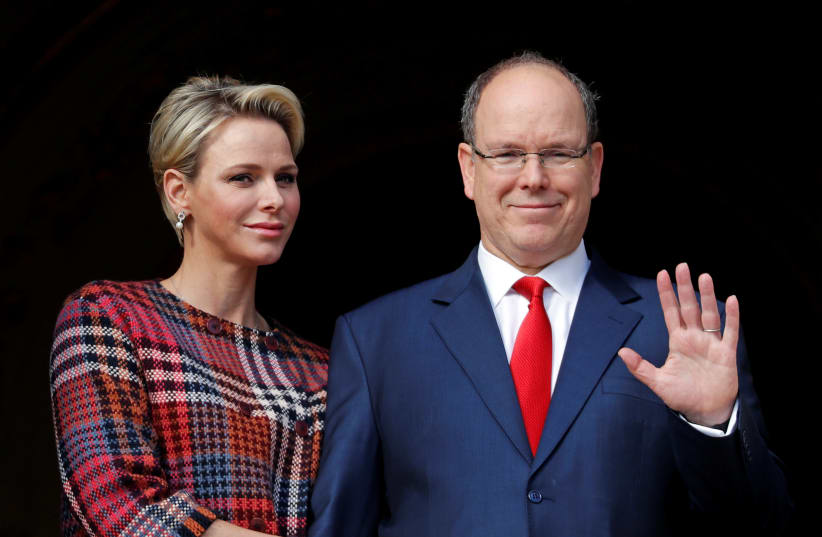 Prince Albert II of Monaco and his wife Princess Charlene stand on the palace balcony during the traditional Sainte Devote procession in Monaco, January 27, 2018.  (photo credit: ERIC GAILLARD/REUTERS)
