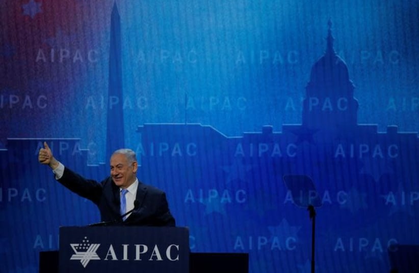  Israeli Prime Minister Benjamin Netanyahu takes the stage to speak at the AIPAC policy conference in Washington, DC, US, March 6, 2018 (photo credit: REUTERS/BRIAN SNYDER)