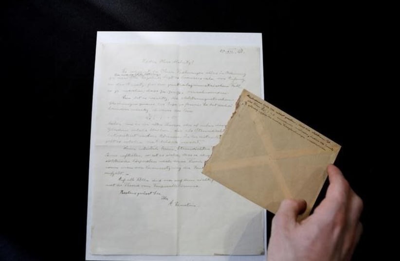  A letter written by Albert Einstein in 1928, in which according to the auction house he outlined ideas for his "Third Stage of the Theory of Relativity", is seen before it is sold at an auction in Jerusalem, March 6, 2018 (photo credit: REUTERS/Ronen Zvulun)