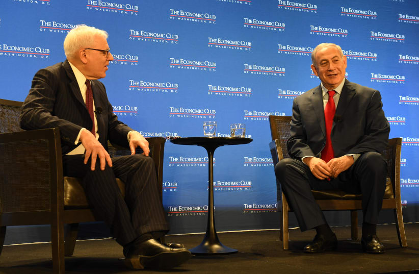 Prime Minister Benjamin Netanyahu in an onstage interview with David Bloomberg at the Economic Club in Washington D.C, March 2018 (photo credit: CHAIM TZACH/GPO)