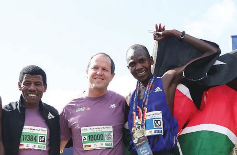 Jerusalem Marathon winner Shadrack Kipkogey (right) next to Jerusalem Mayor Nir Barkat (center) and legendary Ethiopian runner Haile Gebrselassie (left)  (photo credit: Courtesy)