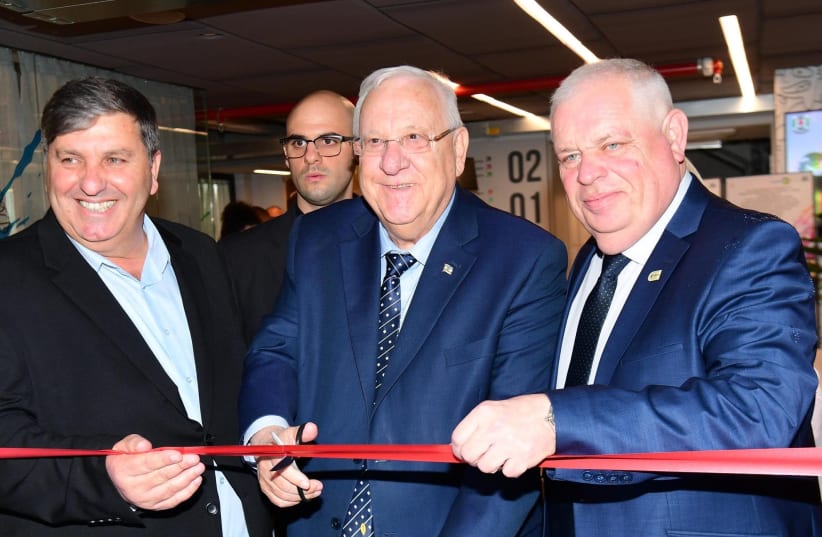 President Reuven Rivlin cuts the ribbon at the unveiling of a new JNF-KKL school in Upper Nazareth, Israel, March 2018 (photo credit: AMOS BEN-GERSHOM/GPO)
