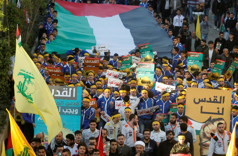 Supporters of Lebanon's Hezbollah protest in Beirut's southern suburbs, Lebanon (photo credit: AZIZ TAHER/REUTERS)