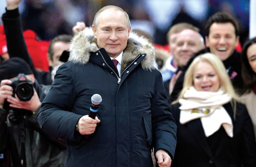 RUSSIAN PRESIDENT Vladimir Putin attends an election rally earlier this month (photo credit: REUTERS)