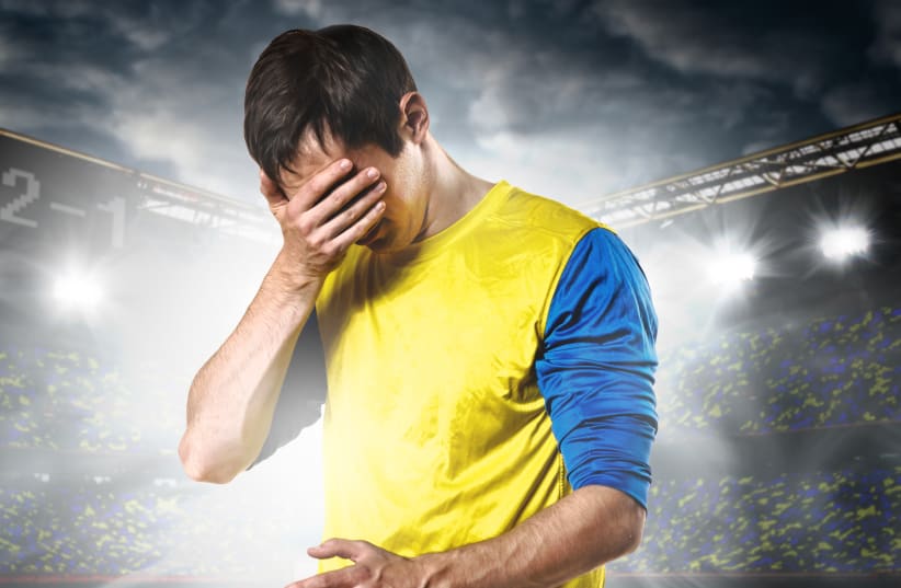 Illustrative photo of a soccer player hiding his face (photo credit: INGIMAGE)