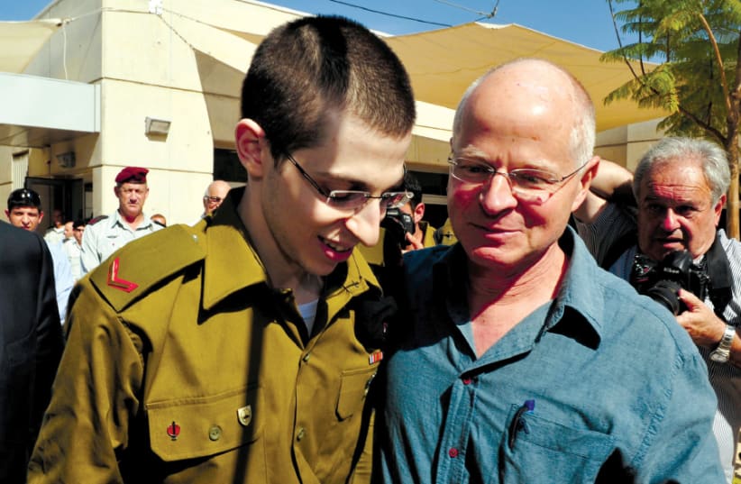 GILAD SCHALIT is reunited with his father, Noam, at the Tel Nof air base in 2011 after  ve years being held in captivity (photo credit: ARIEL HERMONI/IDF/REUTERS)