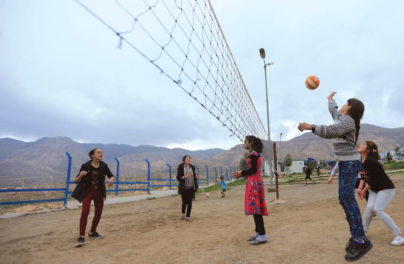 YAZIDI STUDENTS play last month near the psychotherapy center in the Rawanga camp in Iraq. (photo credit: REUTERS)