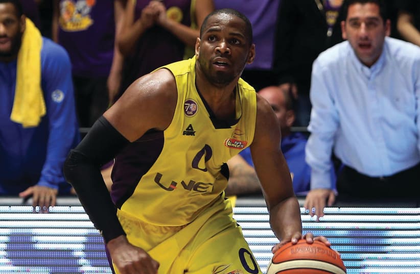 Hapoel Holon guard Tu Holloway scored a team-high 28 points in an 86-81 overtime win over Maccabi Tel Aviv in BSL action. (photo credit: UDI ZITIAT)
