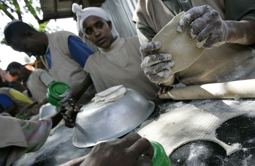 Jewish Ethiopians make matzah in preparation for Passover at a compound while awaiting immigration to Israel in Gondar March 9, 2007 (photo credit: ELIANA APONTE/REUTERS)