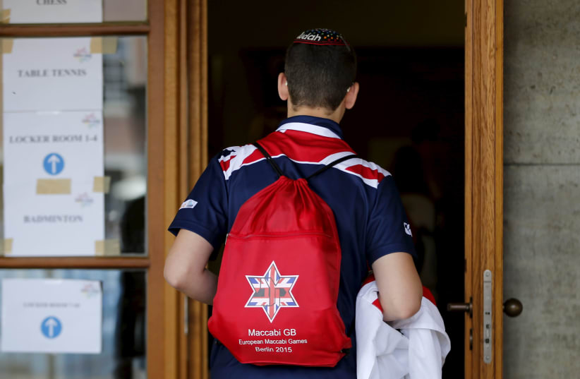 A British Jewish athlete walks to an entrance of the 14th European Maccabi Games at the Olympic park in Berlin, Germany (photo credit: REUTERS/FABRIZIO BENSCH)