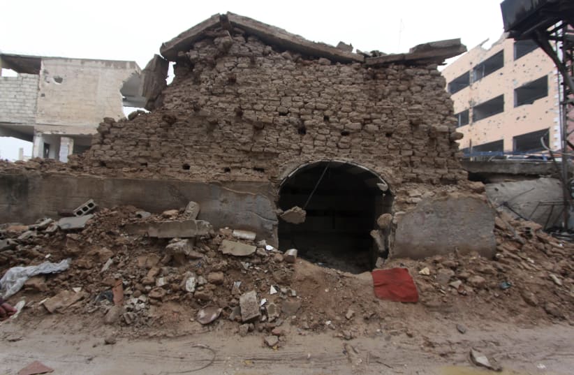A damaged synagogue is seen in the Damascus suburb of Jobar December 14, 2014. The shrine and synagogue of prophet Eliahou Hanabi, dates back to 720 B.C. (photo credit: REUTERS/MOHAMMED BADRA)