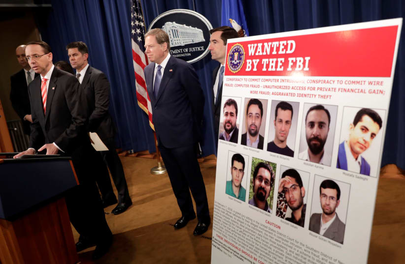 U.S. Deputy Attorney General Rod Rosenstein speaks at a news conference with other law enforcement officials at the Justice Department to announce nine Iranians charged with conducting massive cyber theft campaign, in Washington, U.S., March 23, 2018. (photo credit: REUTERS/YURI GRIPAS)